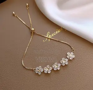 Adjustable Gold-Tone Bolo Bracelet with Floral Charms
