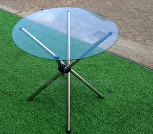 Round Glass-Top Dining Table with Crossed Metal Legs